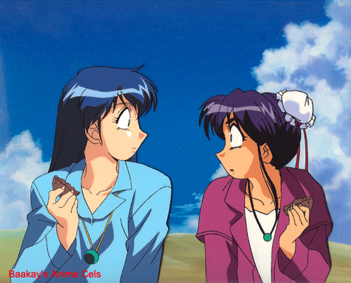 Katsumi and Lum peer at each other in shock after they break a chocolate cookie in half.