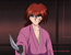 Kenshin draws his sword with a warning gesture.
